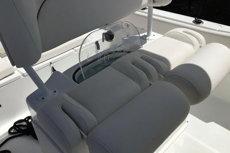 Slide: The Image of 2020 Sea Hunt Ultra 225 boat interior with cushioned seating and storage. - 34