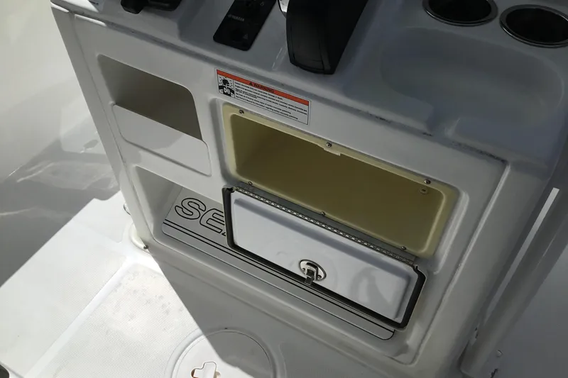 Slide: The Image of 2020 Sea Hunt Ultra 225 boat console with open storage compartment. - 35