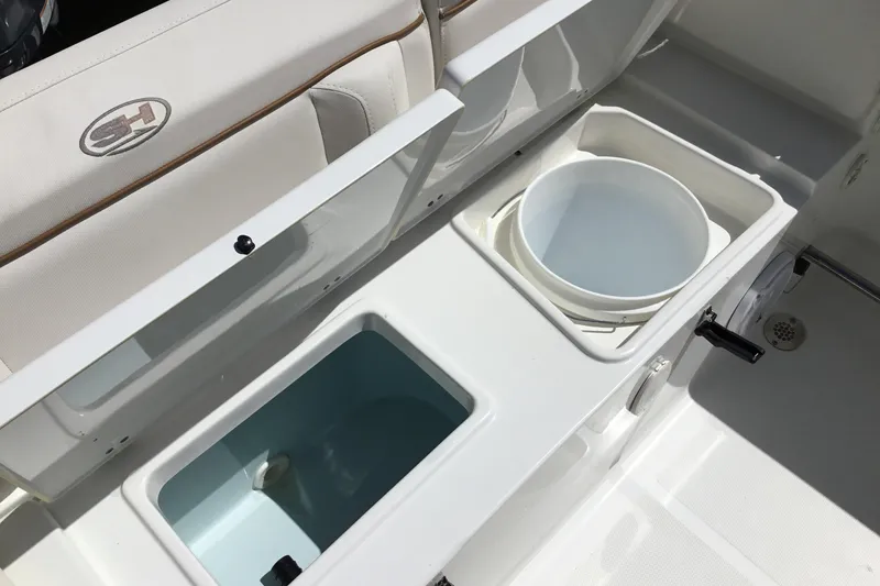 Slide: The Image of 2020 Sea Hunt Ultra 225 boat interior with storage compartments and seating. - 39