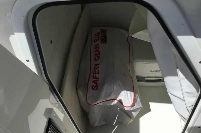Slide: The Image of Storage compartment in 2020 Sea Hunt Ultra 225 with safety gear bag. - 41