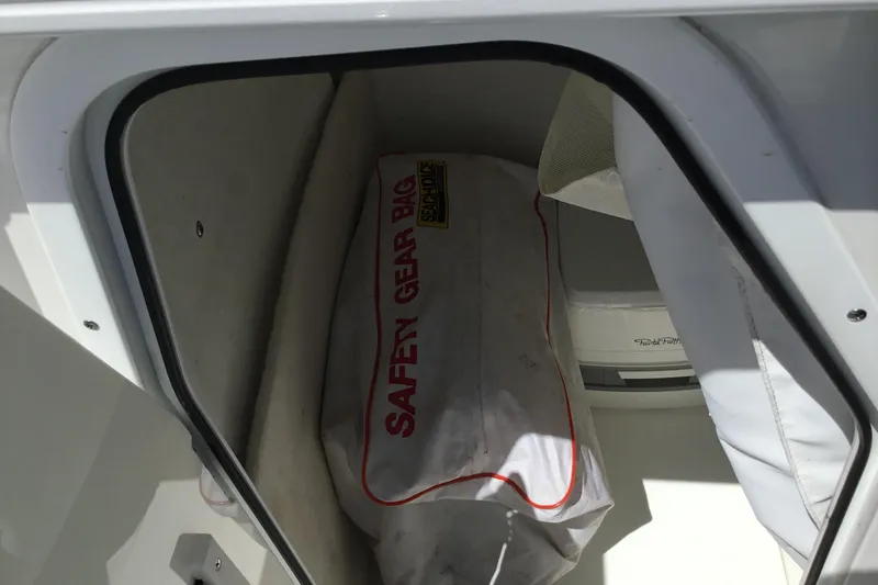 Slide: The Image of Storage compartment with safety gear bag on a 2020 Sea Hunt Ultra 225 boat. - 42