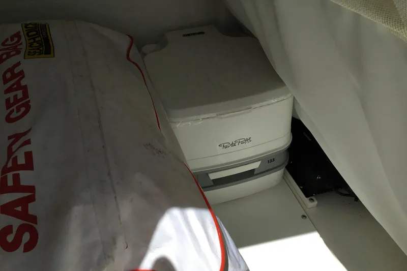 Slide: The Image of Portable toilet and safety gear on 2020 Sea Hunt Ultra 225 boat. - 43