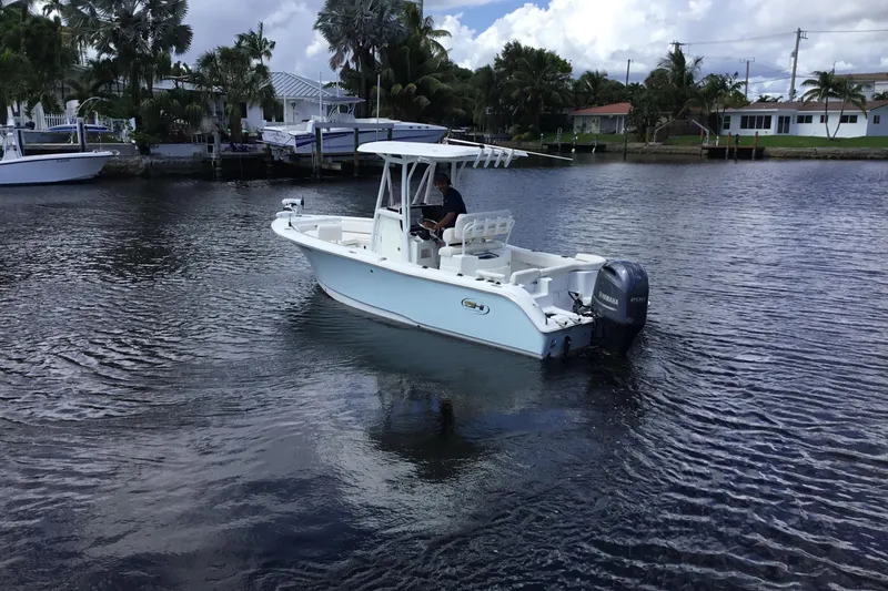 Slide: The Image of 2020 Sea Hunt Ultra 225 boat cruising on a calm waterway. - 9