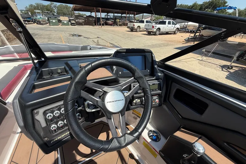 Slide: The Image of 2019 Moomba Makai boat dashboard with steering wheel and control panel. - 12
