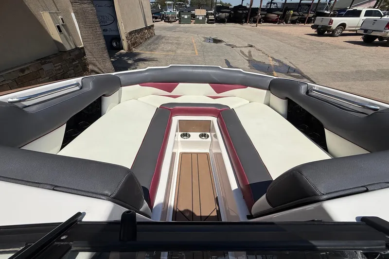 Slide: The Image of 2019 Moomba Makai boat interior with cushioned seating and cup holders. - 14
