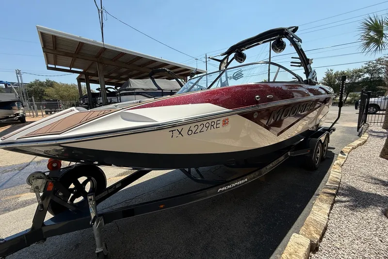 Slide: The Image of 2019 Moomba Makai boat on trailer, parked outdoors under clear sky. - 4