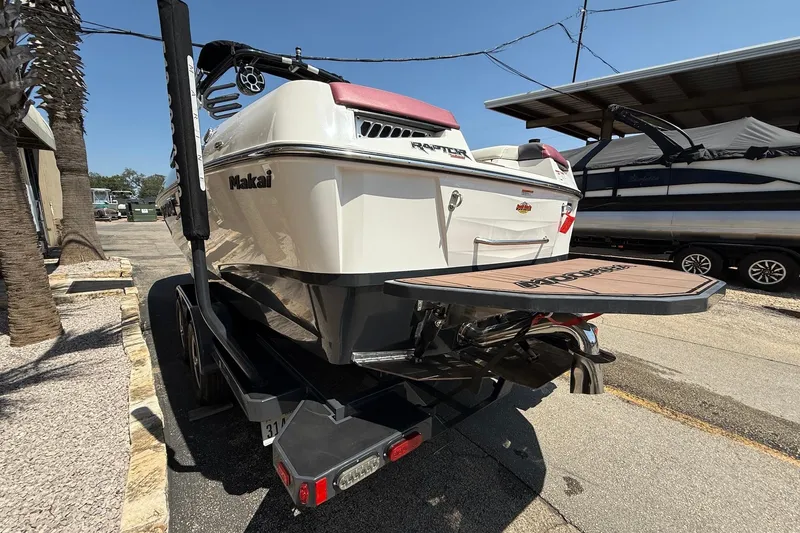 Slide: The Image of 2019 Moomba Makai boat on trailer, rear view with swim platform and Raptor engine. - 5