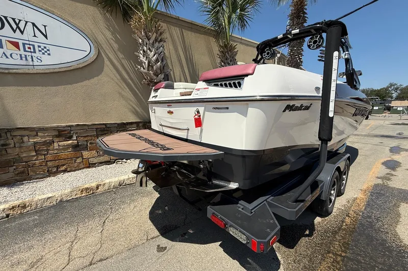 Slide: The Image of 2019 Moomba Makai boat on trailer, parked near a yacht dealership. - 7