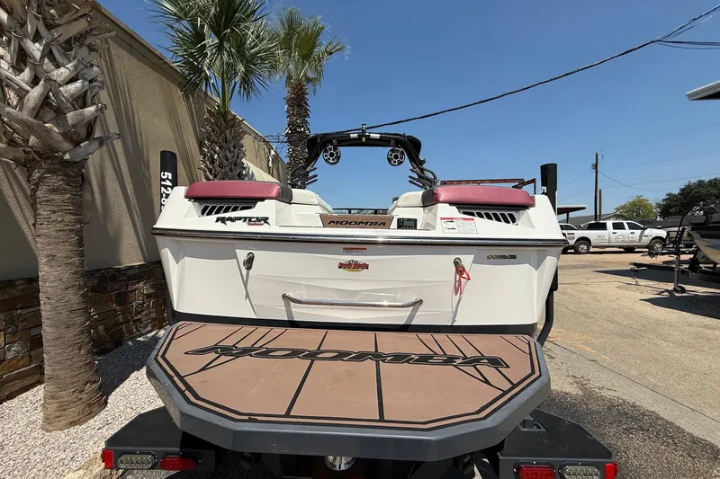 Slide: The Image of 2019 Moomba Makai boat with Raptor engine, parked outdoors under clear sky. - 8