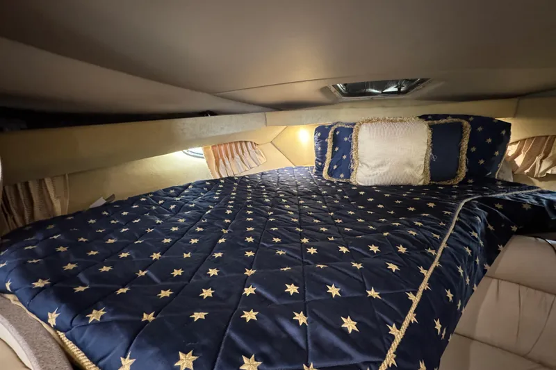 Slide: The Image of Luxurious cabin interior of 2004 Regal Commodore 3260 with star-patterned bedding. - 11