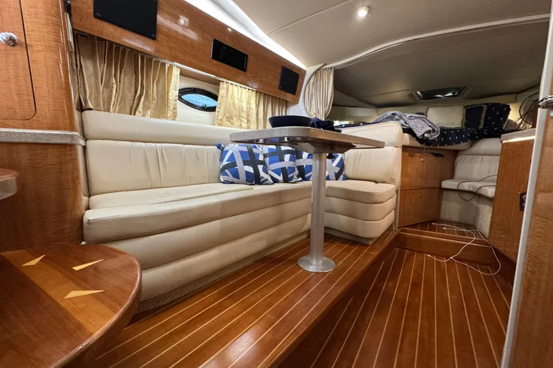 Slide: The Image of Interior of 2004 Regal Commodore 3260 yacht with elegant seating and wooden flooring. - 13
