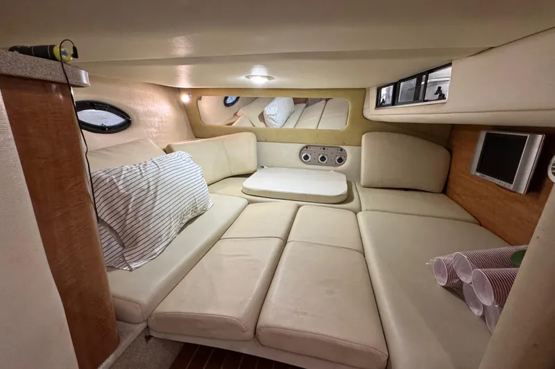 Slide: The Image of Interior of 2004 Regal Commodore 3260 boat with cozy seating and modern amenities. - 14