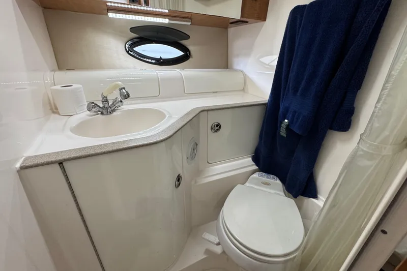 Slide: The Image of Bathroom interior of 2004 Regal Commodore 3260 yacht with sink and toilet. - 16