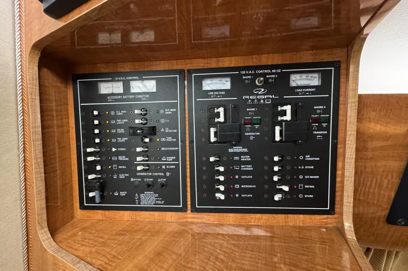 Slide: The Image of Control panel of a 2004 Regal Commodore 3260 boat, featuring electrical switches and gauges. - 17