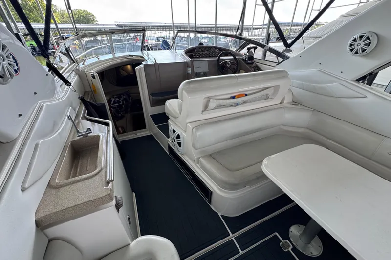 Slide: The Image of 2004 Regal Commodore 3260 yacht interior with white seating, table, and sink. - 20