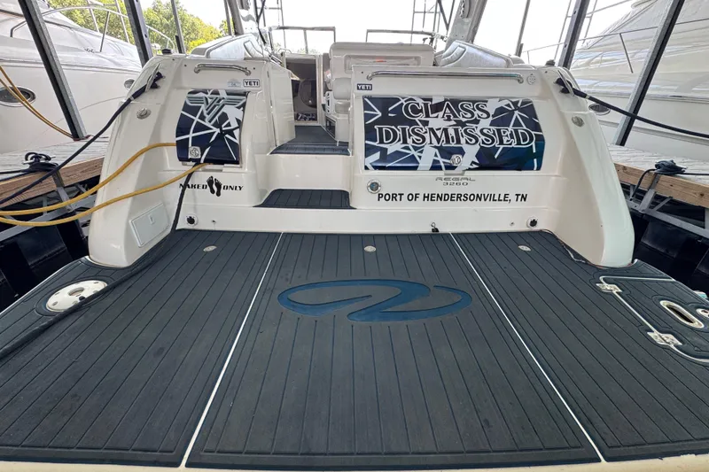 Slide: The Image of 2004 Regal Commodore 3260 boat docked, featuring "Class Dismissed" signage, Port of Hendersonville, TN. - 21