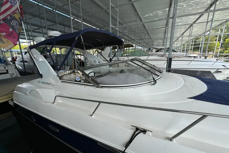Slide: The Image of 2004 Regal Commodore 3260 boat docked in a covered marina. - 23