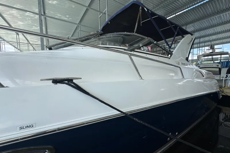 Slide: The Image of 2004 Regal Commodore 3260 boat docked in a covered marina. - 5