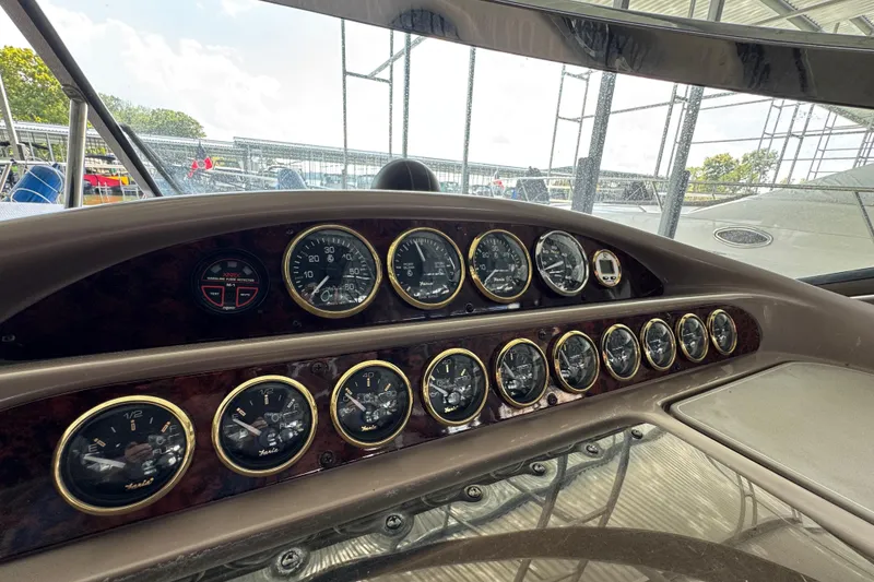 Slide: The Image of Dashboard of 2004 Regal Commodore 3260 boat with multiple gauges and controls. - 8
