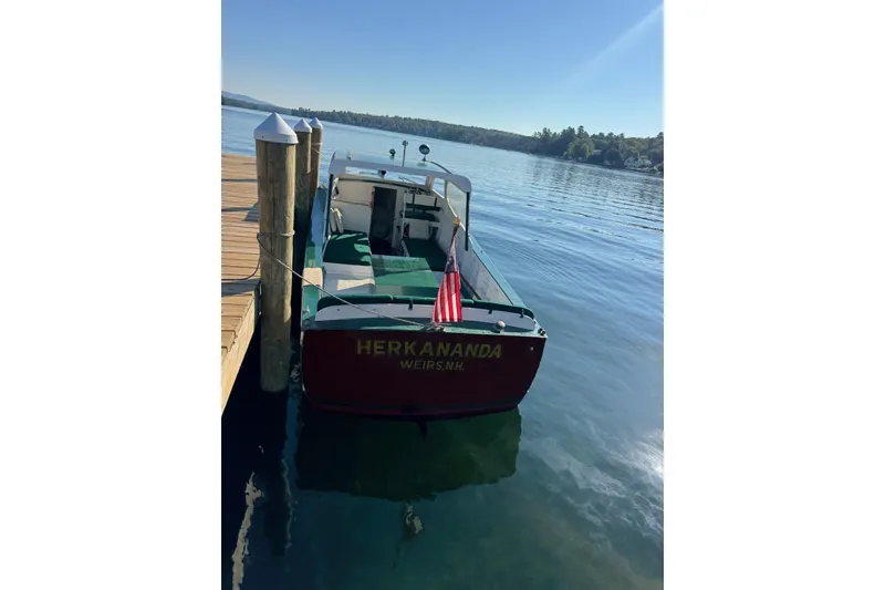 Slide: The Image of 1940 Chris-Craft Launch 25 boat docked on a serene lake. - 18