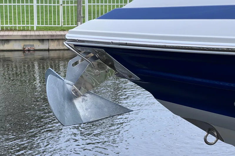 Slide: The Image of 2022 Crownline 290 XSS boat anchor detail by water. - 11