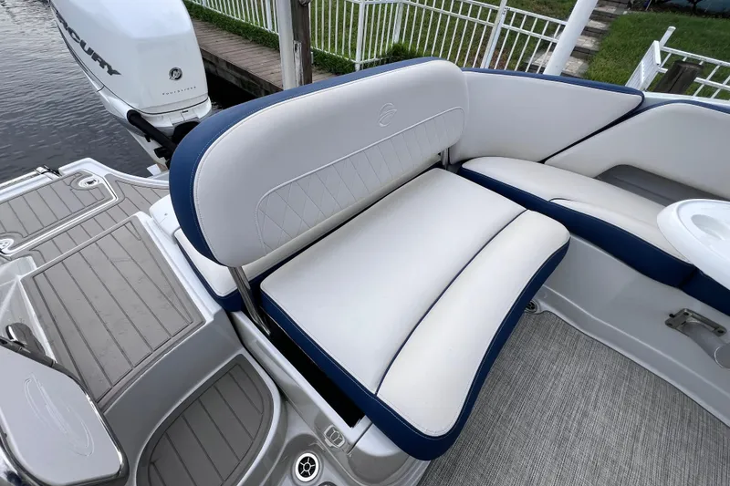 Slide: The Image of 2022 Crownline 290 XSS boat interior with white and blue seating. - 21