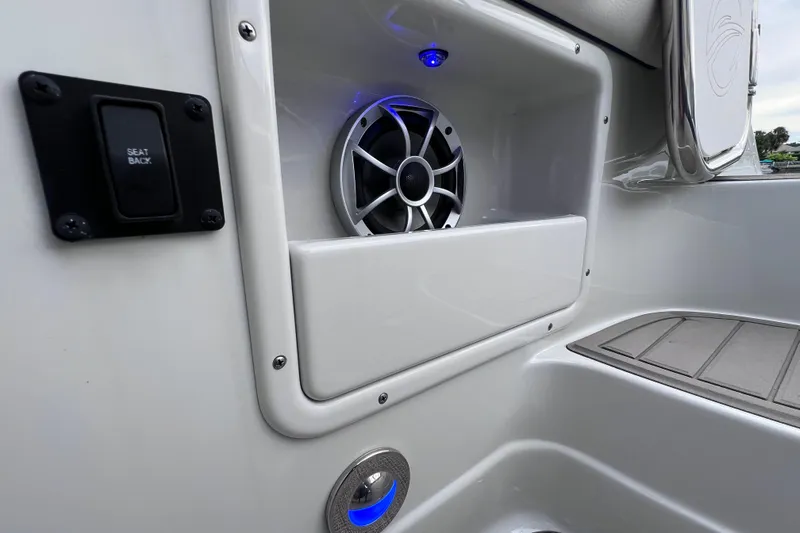 Slide: The Image of 2022 Crownline 290 XSS boat interior with speaker and seat back control. - 22