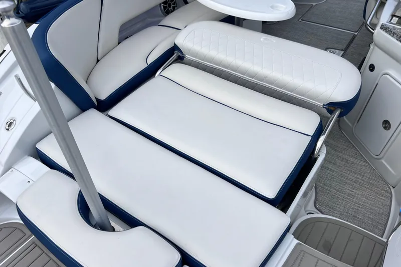 Slide: The Image of Luxurious seating on 2022 Crownline 290 XSS boat, featuring white and blue upholstery. - 24