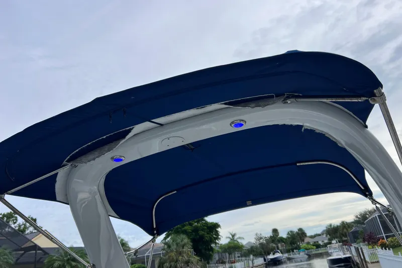 Slide: The Image of 2022 Crownline 290 XSS boat canopy with blue cover and metal frame. - 35