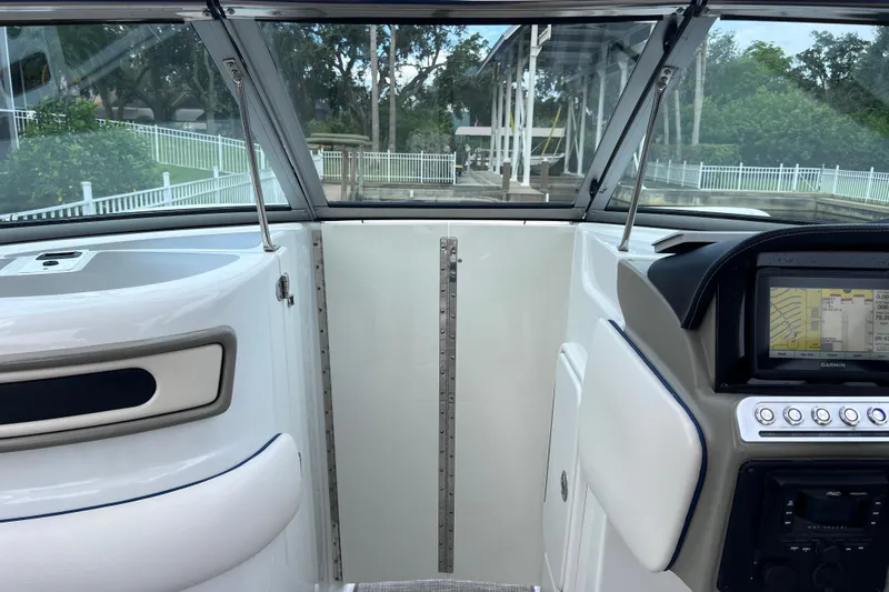 Slide: The Image of 2022 Crownline 290 XSS boat interior with navigation system and windshield view. - 40