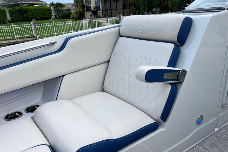 Slide: The Image of Luxurious seating on 2022 Crownline 290 XSS boat with white and blue upholstery. - 45