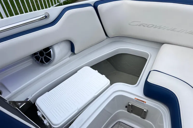Slide: The Image of 2022 Crownline 290 XSS boat interior with storage compartment and speaker. - 47