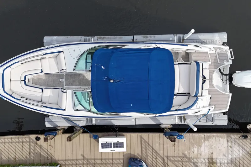 Slide: The Image of Overhead view of 2022 Crownline 290 XSS boat docked with blue canopy. - 5