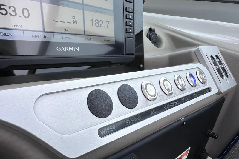 Slide: The Image of Dashboard of 2022 Crownline 290 XSS boat with Garmin display and control buttons. - 54
