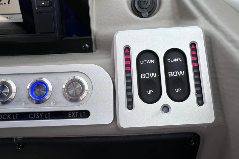 Slide: The Image of Control panel of 2022 Crownline 290 XSS boat with trim and light switches. - 55