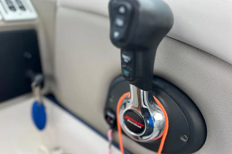 Slide: The Image of Throttle control of 2022 Crownline 290 XSS boat, featuring ergonomic design and controls. - 58