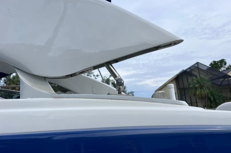 Slide: The Image of 2022 Crownline 290 XSS boat detail with sleek white and blue design. - 60