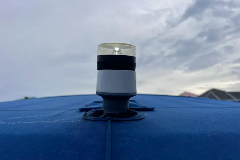 Slide: The Image of Navigation light on 2022 Crownline 290 XSS boat against cloudy sky. - 61