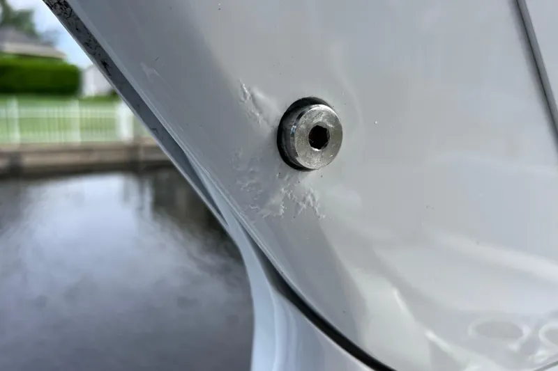 Slide: The Image of Close-up of a 2022 Crownline 290 XSS boat's hull with a visible bolt. - 62