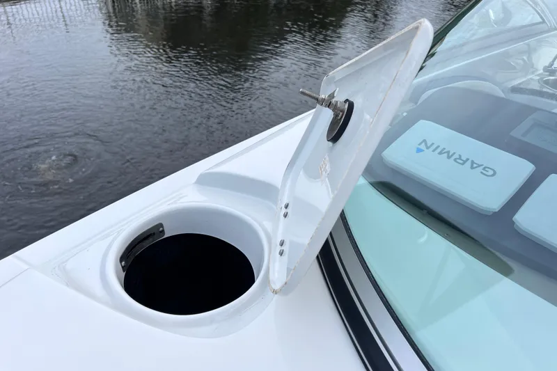 Slide: The Image of Open hatch on 2022 Crownline 290 XSS boat with Garmin equipment visible. - 70