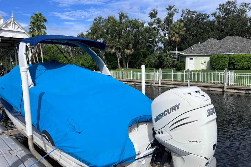 Slide: The Image of 2022 Crownline 290 XSS boat with blue cover and Mercury 350 Verado engine. - 73