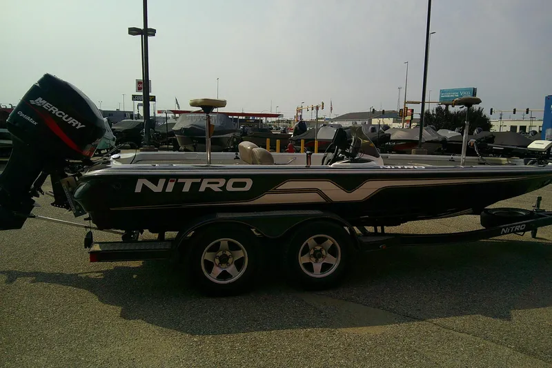 Slide: The Image of 1997 Nitro Savage 896 boat with Mercury outboard motor on a trailer. - 7