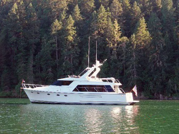 The Image of Ocean Alexander 520 Pilothouse yacht from 1990 on a serene forested lake. - 0
