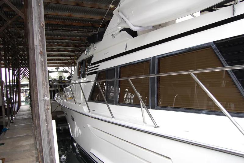 Slide: The Image of 1990 Ocean Alexander 520 Pilothouse yacht docked in a covered marina. - 12