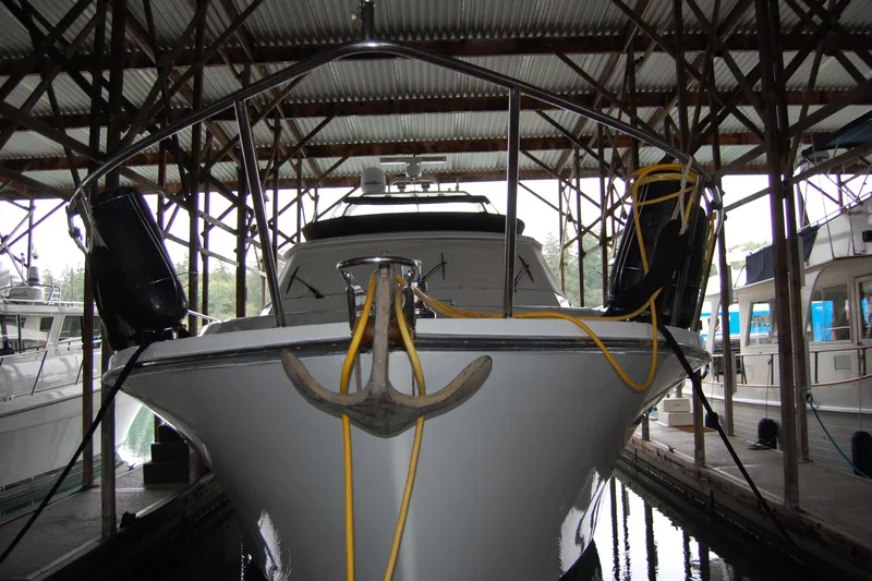 Slide: The Image of 1990 Ocean Alexander 520 Pilothouse yacht docked in a covered marina. - 13