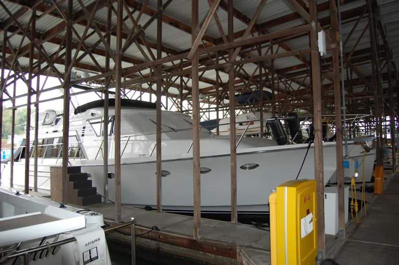 Slide: The Image of 1990 Ocean Alexander 520 Pilothouse yacht docked in a covered marina. - 14