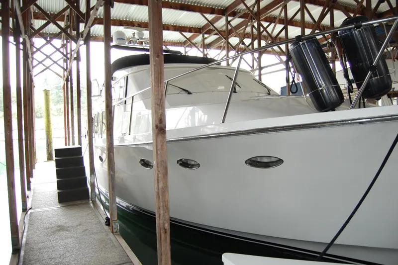 Slide: The Image of 1990 Ocean Alexander 520 Pilothouse yacht docked in covered marina. - 15