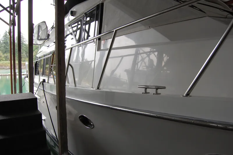 Slide: The Image of 1990 Ocean Alexander 520 Pilothouse yacht docked in a marina, side view. - 16