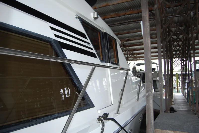 Slide: The Image of 1990 Ocean Alexander 520 Pilothouse yacht docked in a covered marina. - 17
