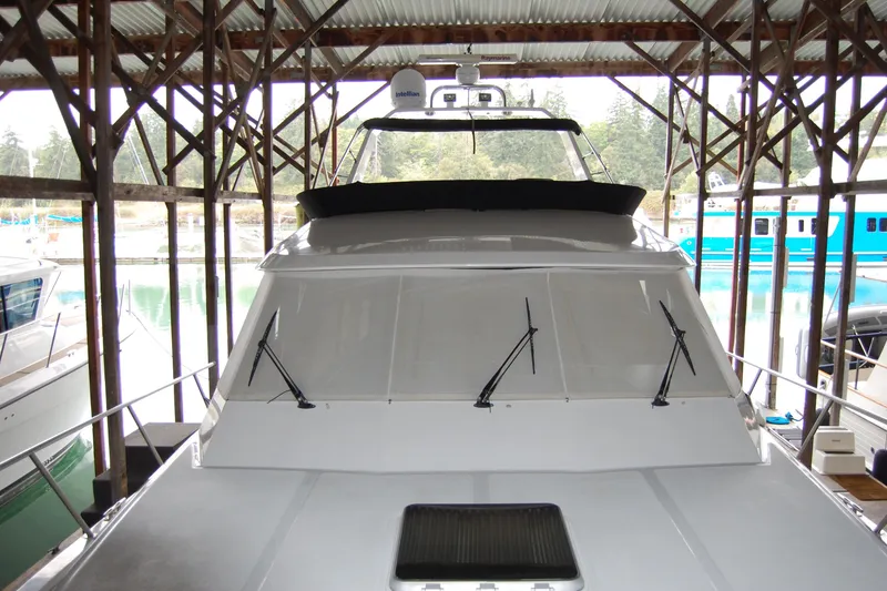Slide: The Image of 1990 Ocean Alexander 520 Pilothouse yacht docked in a covered marina. - 19